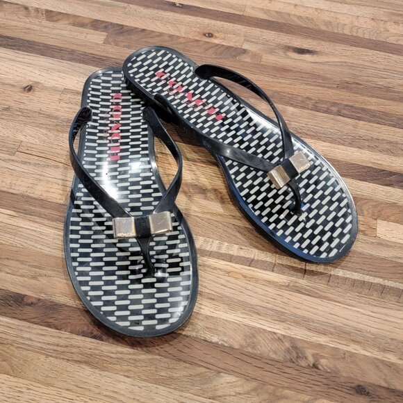 Coach Landon jelly flip flops in black with a gold bow and white pattern. - Picture 1 of 12